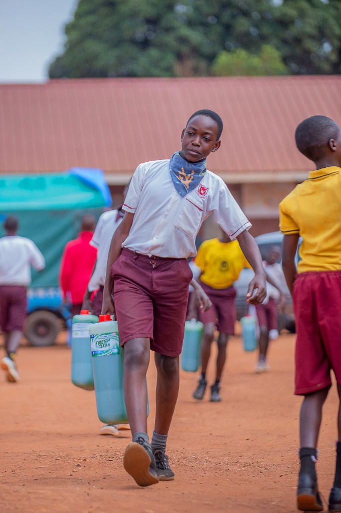 Student proudly displaying liquid soap products from practical life skills sessions
